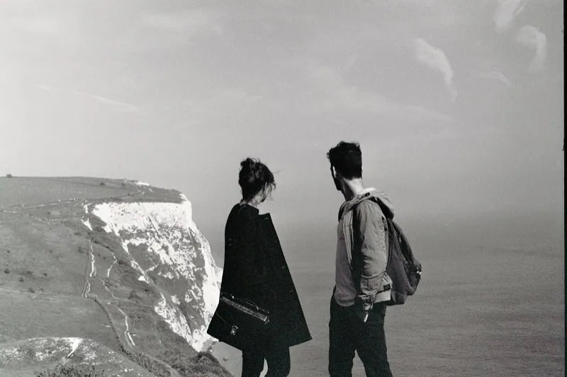 Two people looking out over the White Cliffs of Dover