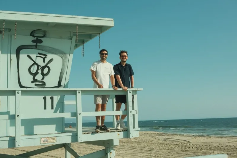 Two friends on a lifeguard tower at the beach